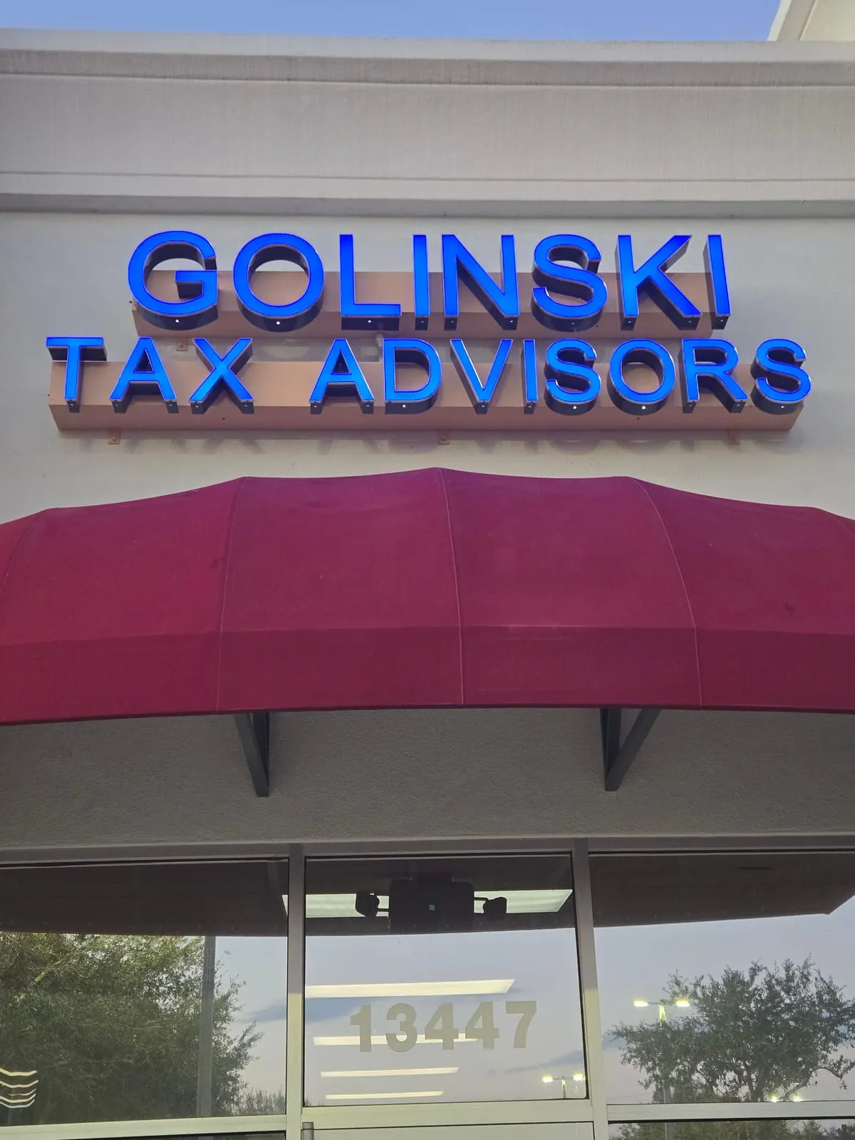 Golinski Tax Prep letter sign and burgundy awning above the office door at 13447 County Line Road, Spring Hill